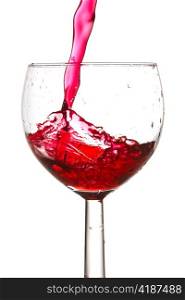 red wine pouring into glass. isolated on white background