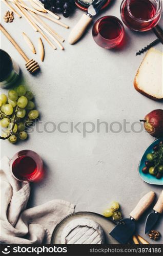 Red wine with charcuterie assortment on rustic concrete background, flat lay, copyspace, food frame
