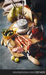 Red wine with charcuterie assortment on the stone background. Wine and snack set
