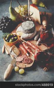 Red wine with charcuterie assortment on the stone background. Wine and snack set