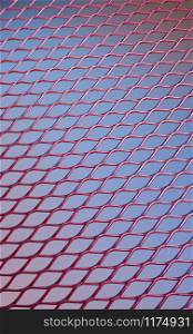 Red wire mesh on a blue background.