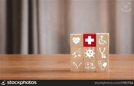 Red wood block of plus sign on icon wooden arrangement. Healthcare and Medical concept. Insurance good heath. Patient beware virus. hospital treatment. Family Safety. Medicine protect. virus problem.