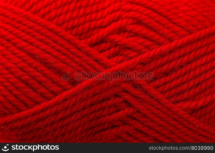 red woolen thread is wound beautiful closeup