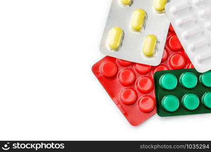 Red, yellow, green and white pills blisters of pharmacy to cure pain and illness