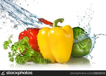 red, yellow, green pepper and parsley with water splash isolated on white