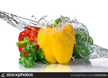 red, yellow, green pepper and parsley with water splash isolated on white