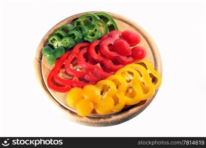 Red yellow orange green pepper on the chopping board. (isolated)