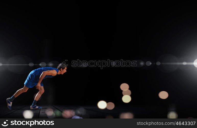 Reday to run. Young man athlete standing in start pose