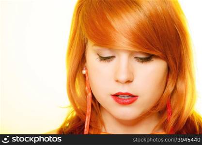 Redhair girl portrait wearing sweet red jelly candy earrings on yellow