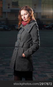 redhead 20s women standing outdoor in autumn park, weared scarf and coat