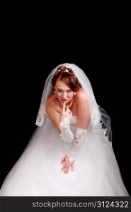 Redhead bride in a white dress with a black background