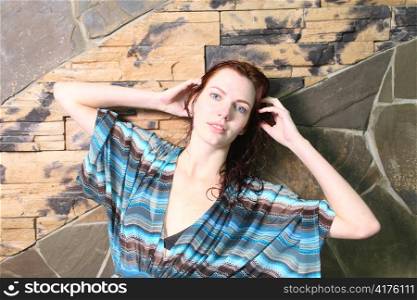 redhead brown eyes beautiful girl standing by stone wall