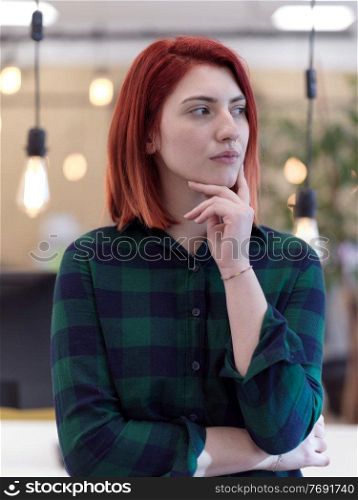redhead business woman portrait as influencer in creative modern coworking startup open space office. redhead business woman portrait in creative modern coworking startup open space office