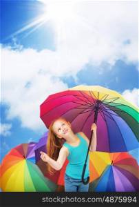 Redhead girl holding a colorful umbrella
