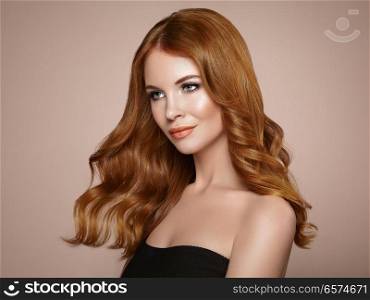 Redhead Girl with Long Healthy and Shiny Curly Hair. Care and Beauty. Beautiful Model Woman with Wavy Hairstyle. Make-Up and Black Dress