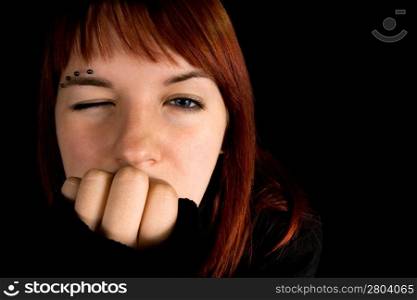 Redhead girl with one eye closed. Lit with three flashes, hair light green.