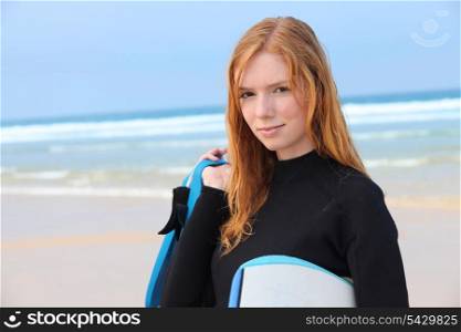 Redhead girl with surfboard