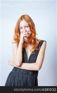 redhead in studio, close her mouth by hand