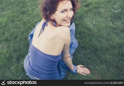 redhead smiling on grass, vintage looking photo shot