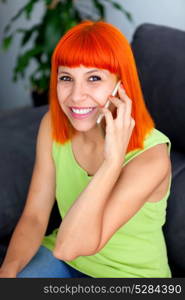 Redhead woman calling with her mobile at home