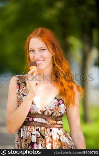 Redhead Woman eating ice-cream sunny day outdoors