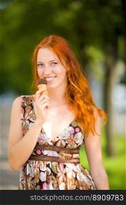 Redhead Woman eating ice-cream sunny day outdoors
