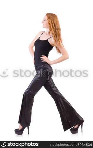 Redhead woman in black bell bottom pants on white