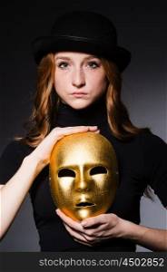 Redhead woman in hat iwith mask in hypocrisy consept against dark grey background