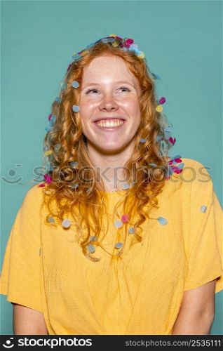redhead woman partying with confetti her hair