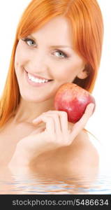 redhead woman with red apple in water