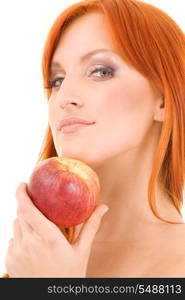 redhead woman with red apple over white