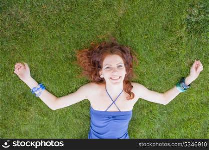 redhead women on grass looking at camera