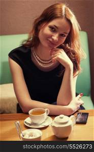 redhead women sitting in cafe front view
