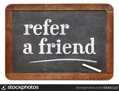 refer a friend - white chalk text on a vintage slate blackboard