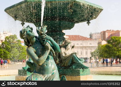 Refined fountain on the square with woman sculpture, Portugal. Fountain on the square