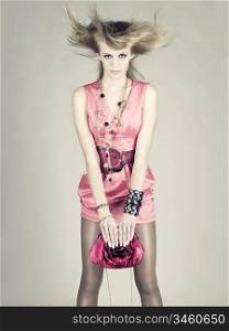 Refined young lady loves her bag. Fashion photo