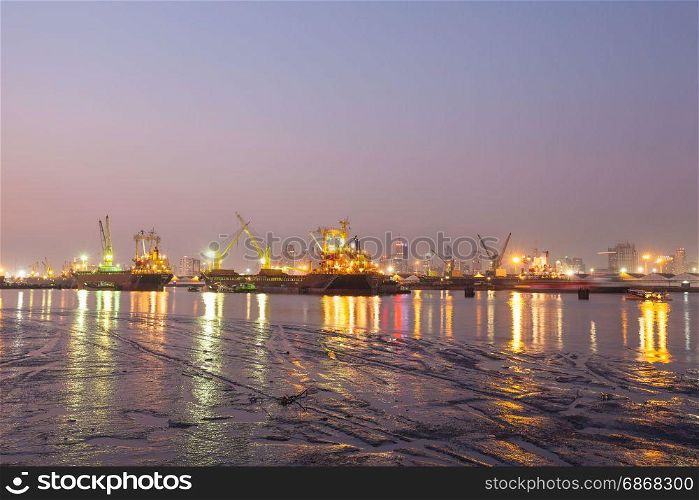 Refinery at night Light and oil tanker landing docks