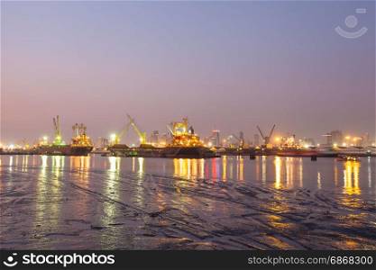 Refinery at night Light and oil tanker landing docks