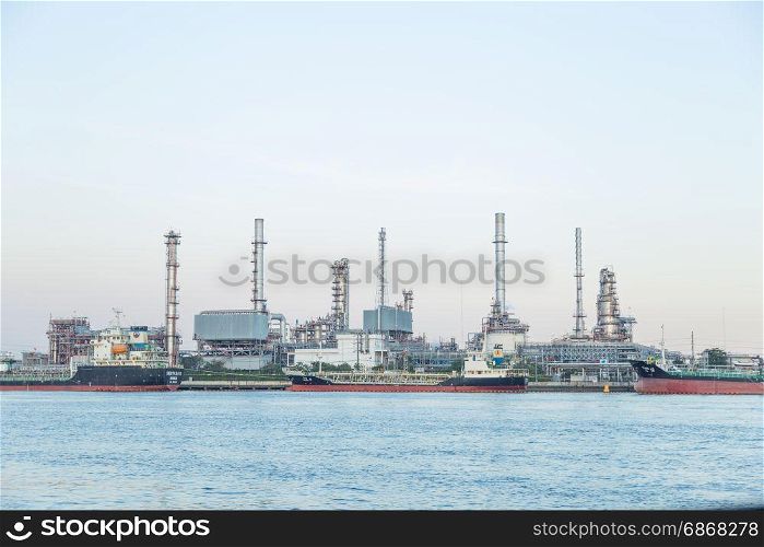 Refinery in the daytime On the riverside for shipping dock.