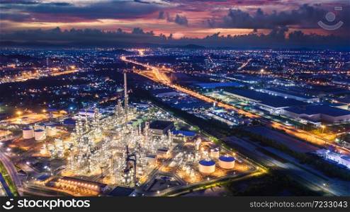 refinery industry zone at night and lighting cityscape with twilight sky background at laem chabang Thailand aerial view from drone