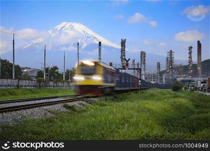 refinery oil and petroleum industry factory zone and containers cargo logistics train transportation open lighting movement foreground with fuji mountain and blue sky background