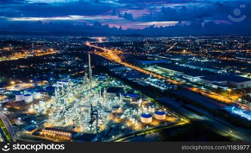refinery zone at night and lighting cityscape with blue sky background aerial view from drone