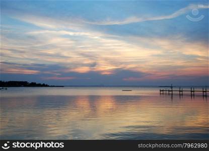 Reflecting water by a colorful sunset at the swedish island Oland in the Baltic Sea