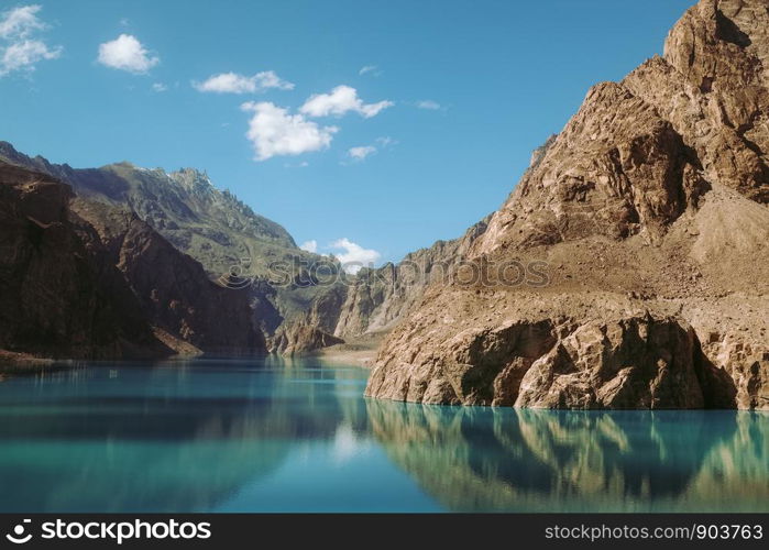 Reflection in the water of Attabad Lake, surrounded by mountains in Karakoram range. Gojal Hunza, Gilgit Baltistan, Pakistan.