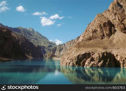 Reflection in the water of Attabad Lake, surrounded by mountains in Karakoram range. Gojal Hunza, Gilgit Baltistan, Pakistan.