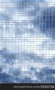 Reflection of a cloudy sky in glass wall of an office building