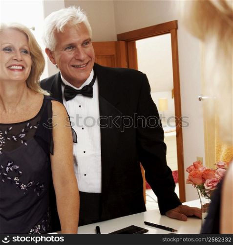 Reflection of a mature couple smiling on a mirror
