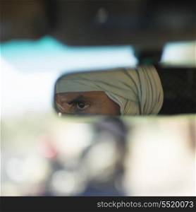 Reflection of a Tuareg man in the rear-view mirror, Atlas Mountains, Morocco