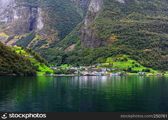 Reflection of asmall town in a norwegian fiord, Norway