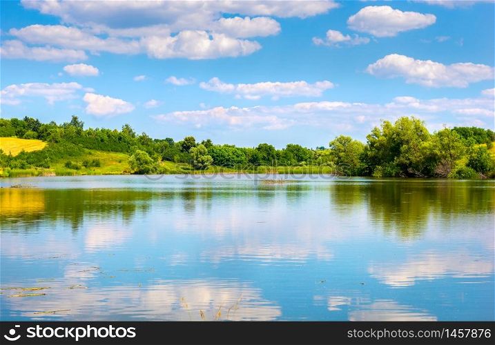 Reflection of blue cloudy sky in calm river. Reflection of sky in river